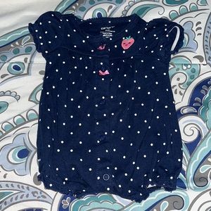 Blue with polkadot designs and a pink strawberry in the back.